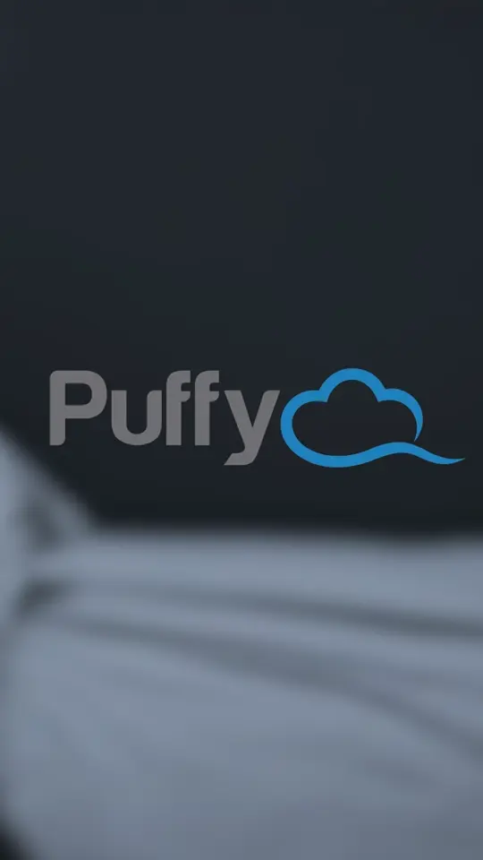 Puffy Mattress logo above a softly lit mattress